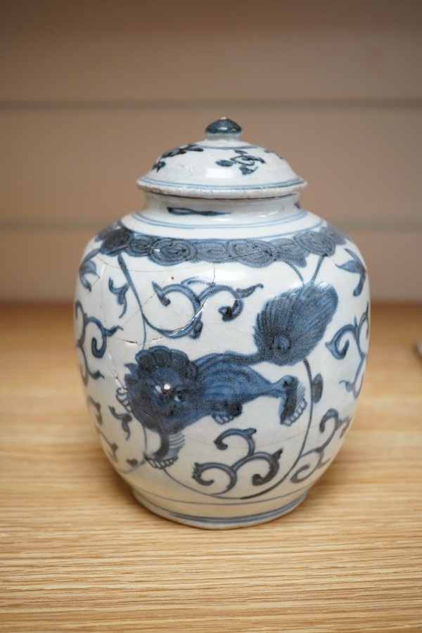 A Chinese blue and white Lion-dog jar and cover, late Ming dynasty, 17cm. Condition - poor